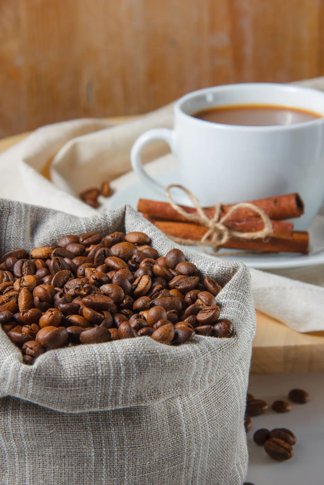 Coffee beans with a jute sack and dry cinnamon